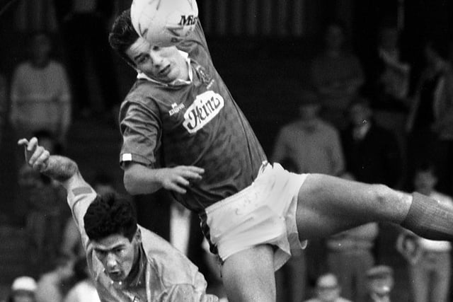 Wigan Athletic central defender Alan Johnson gets the better of former Latics player Mike Newell during Alex Cribley's testimonial match against Everton at Springfield Park on Sunday 6th of May 1990.