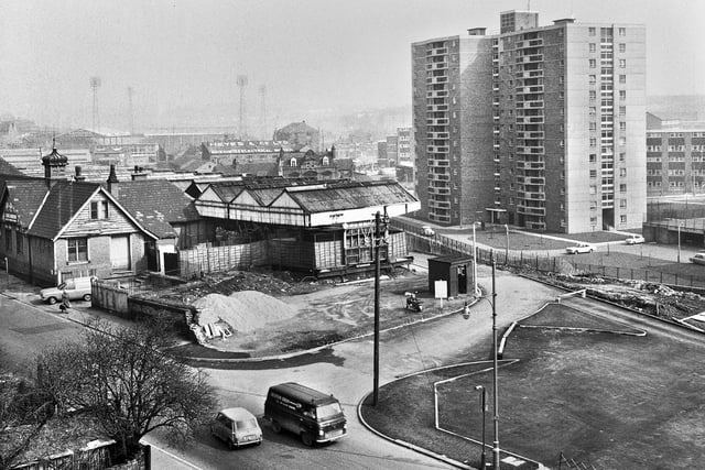 A view across Station Road showing Central Station and the Scholes flats in the foreground with Wigan Little Theatre, Walter Heyes Electrical Works and Central Park in the background in the late 1960s.