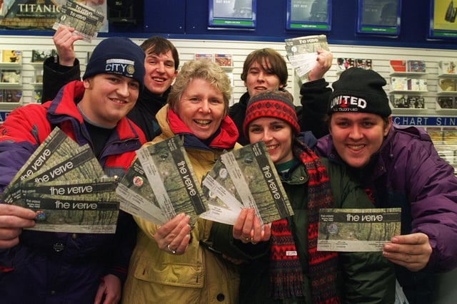 Kitt Barrow, second left, and Michelle Friend, from Abram, who were at the front of the queue at Omega Music, Standishgate, along with James McAdam, left, and Andrew Jones, right, from Bamfurlong, show off their tickets for The Verve concert at the Haigh Hall.