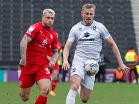 Stephen Humphrys puts pressure on the MK Dons backline