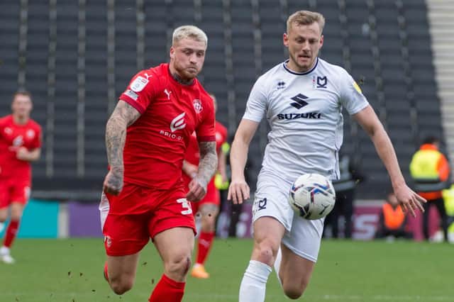 Stephen Humphrys puts pressure on the MK Dons backline