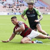 Mitch Clark scores against Huddersfield at the DW Stadium in Super League Round 14 2021