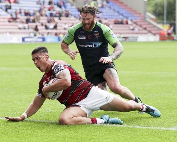 Mitch Clark scores against Huddersfield at the DW Stadium in Super League Round 14 2021