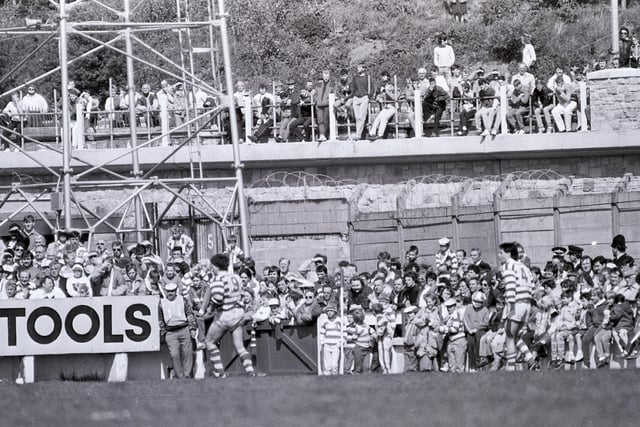 Cheeky fans cop a free view from the newly constructed bridge on River Way at the side of Central Park on May 10th 1987 to watch Wigan v Halifax.
Wigan won the game 18-0