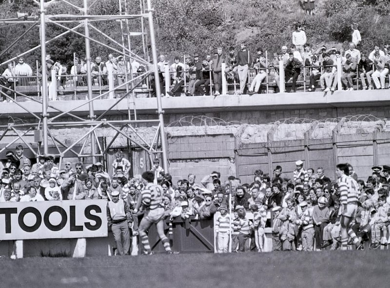 Cheeky fans cop a free view from the newly constructed bridge on River Way at the side of Central Park on May 10th 1987 to watch Wigan v Halifax.
Wigan won the game 18-0