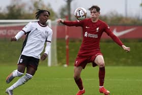 Martial Godo and Luke Chambers - team-mates at Latics last season - do battle for Fulham and Liverpool respectively