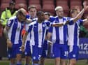 The Latics players celebrate at Crewe
