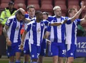 The Latics players celebrate at Crewe