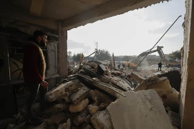 Rescue teams search through the wreckage of collapsed buildings in Aleppo, Syria