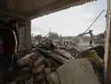 Rescue teams search through the wreckage of collapsed buildings in Aleppo, Syria