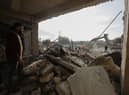 Rescue teams search through the wreckage of collapsed buildings in Aleppo, Syria