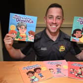 Award-winning author Alex Winstanley with his books