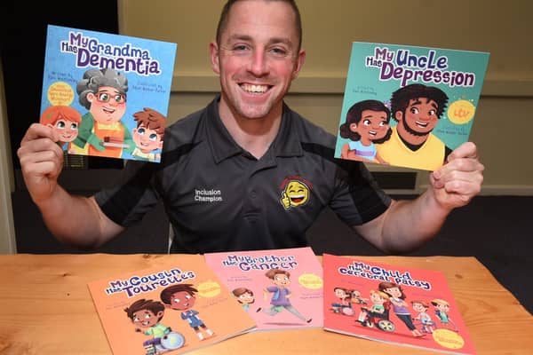 Award-winning author Alex Winstanley with his books
