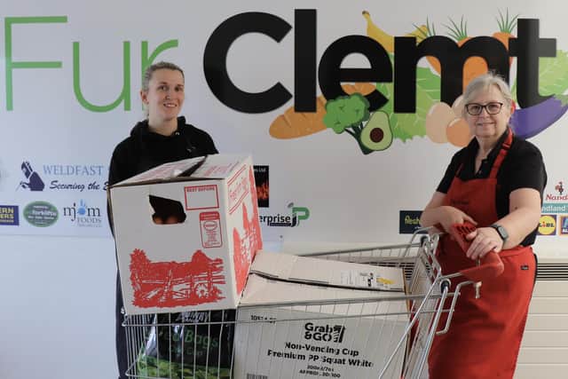 Katy Brittain and Shirley Southworth MBE  from Fur Clemt receive donations from Millennium Care