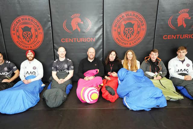 Settling into their sleeping bags are members of Wigan Warriors and The Brick - Ian Thornley, Jake Bibby, Liam Farrell, Martin McLoughlin, Wendy Doherty, Kim Mannion, Kevin Barr and Sam Powell