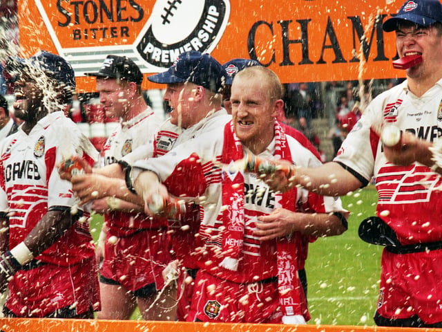 The champagne and beer flow as Wigan players celebrate - Wigan v Leeds