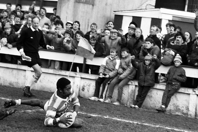 Wigan winger Henderson Gill scores one of his three tries to the delight of fans in a 52-6 league defeat of Workington Town at Central Park on Sunday 17th of March 1985.
