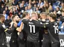 The Latics players enjoy the midweek win at Huddersfield