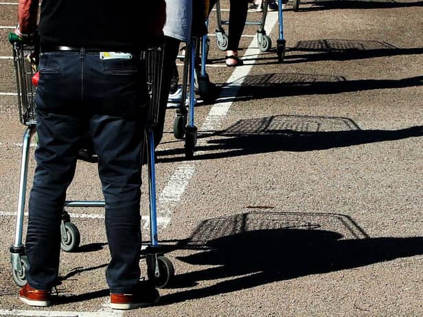 Shoppers queue using safe distance measures at Waitrose supermarket in Rushden, England (Photo: David Rogers/Getty Images)