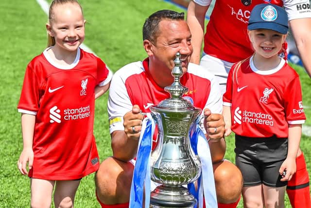 Place2Place long-serving player Scott Westhead gets his hands on the silverware