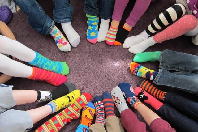 The mis-matching socks represent people and show that it is OK to stand out and be different