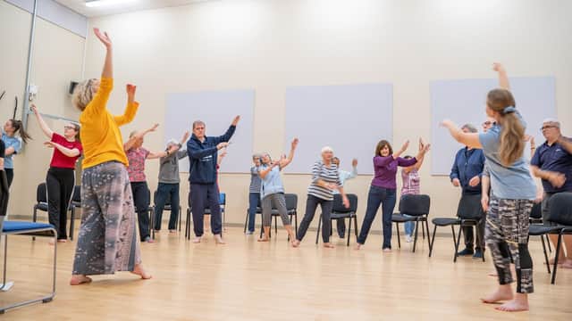 Mel Brierley (in yellow) running a Dance for Parkinson's session