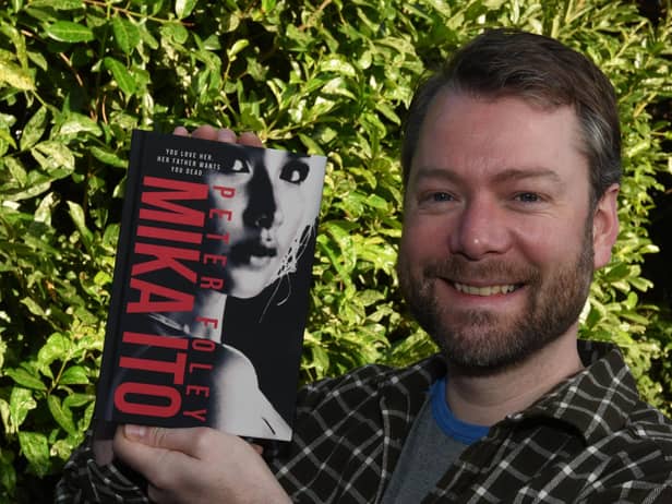 Wigan author Peter Foley, with his second novel, Mika Ito.