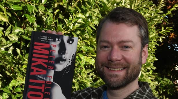 Wigan author Peter Foley, with his second novel, Mika Ito.