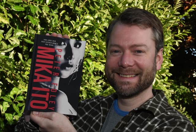 Wigan author Peter Foley, with his second novel, Mika Ito.