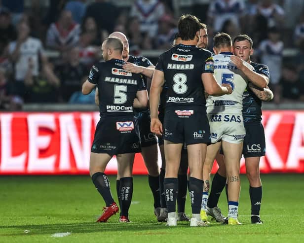 Wigan Warriors and Wakefield Trinity players shake hands after Round 15 clash at the DIY Kitchens Stadium
