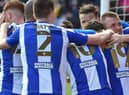 The Latics players celebrate at Lincoln