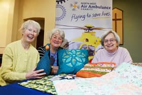 Serendipity Quilters committee members from left, Bernadette Peters, Glenys Rhead and Chris Parker, get ready for the exhibition.