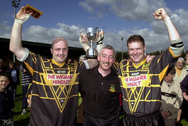 Hindley's joint captains Dave Benson and Mick Hurst and coach Steve Holland celebrate with the trophy after winning the Ken Gee Cup Final beating St. Pat's "A" team 16-12 at Orrell on Sunday 10th of June 2001.