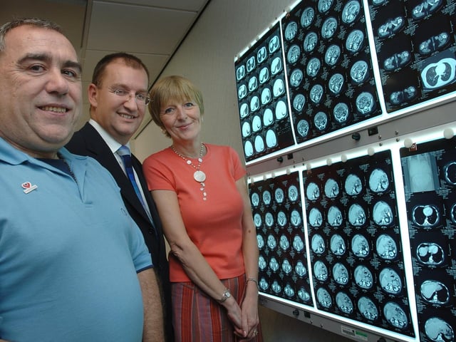 Mr Richard Slade, consultant gynaecologist, centre, shows Carl Sharpe and Janet Atherton, chairman and secretary of Wigan, Leigh and Chorley Fundraisers for The Christie, some X-rays after they presented him with a cheque for £10,000 at The Thomas Linacre Centre. The money, raised through numerous local events by various groups, was to be spent on a diagnostic hystroscope camera and lighting system that can see inside the womb for the diagnosis of gynaecological cancers