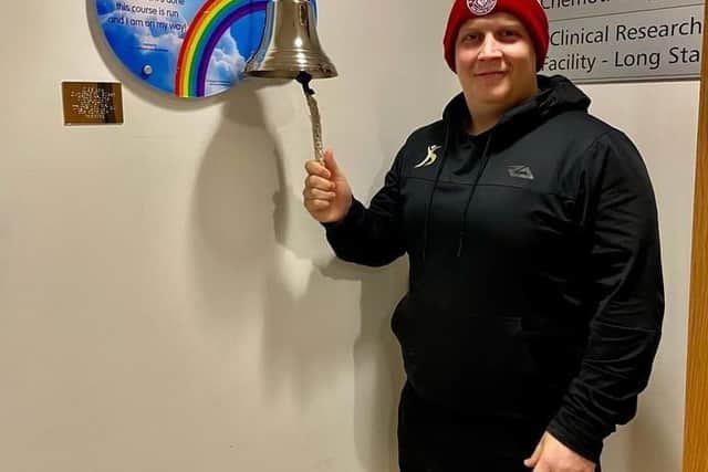 James Whyte ringing the bell at Christie Hospital after being given the all-clear from cancer