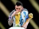 Argentina's Lionel Messi kisses the FIFA World Cup trophy after being presented with the Golden Ball award  (Nick Potts/PA Wire)