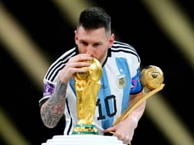 Argentina's Lionel Messi kisses the FIFA World Cup trophy after being presented with the Golden Ball award  (Nick Potts/PA Wire)