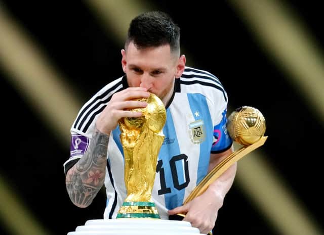 Argentina's Lionel Messi kisses the FIFA World Cup trophy after being presented with the Golden Ball award  (Nick Potts/PA Wire)