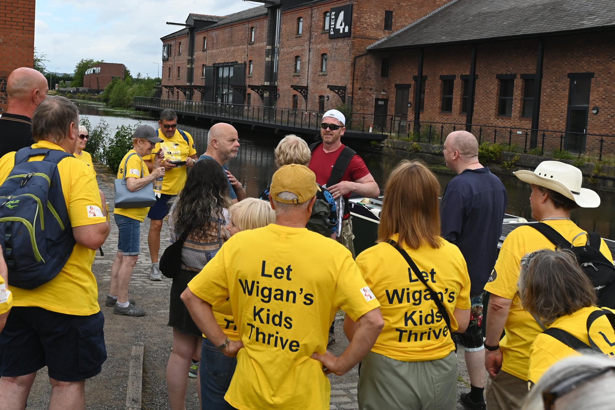 Batting through the pain barrier, a Wigan dad has raised thousands by completing an excruciating sequence of challenges including dragging a 15-tonne barge