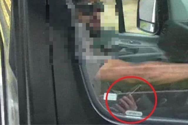A driver seen using his mobile phone at the wheel