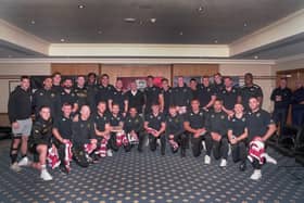 Sir Alex Ferguson presented the Wigan players with their Grand Final shirts
