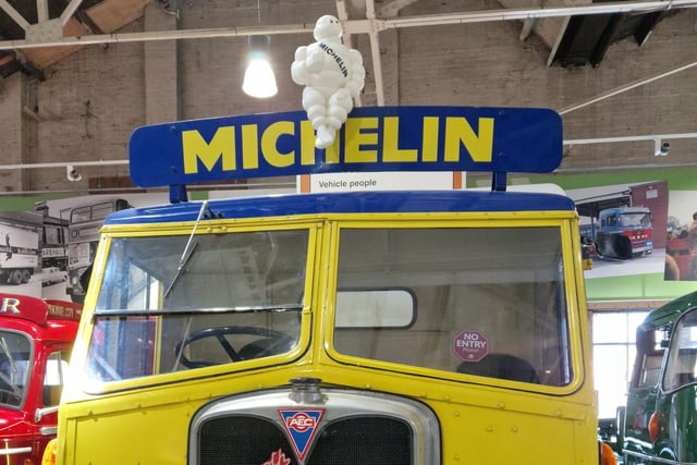 The Michelin Man sits proudly on top of an old truck