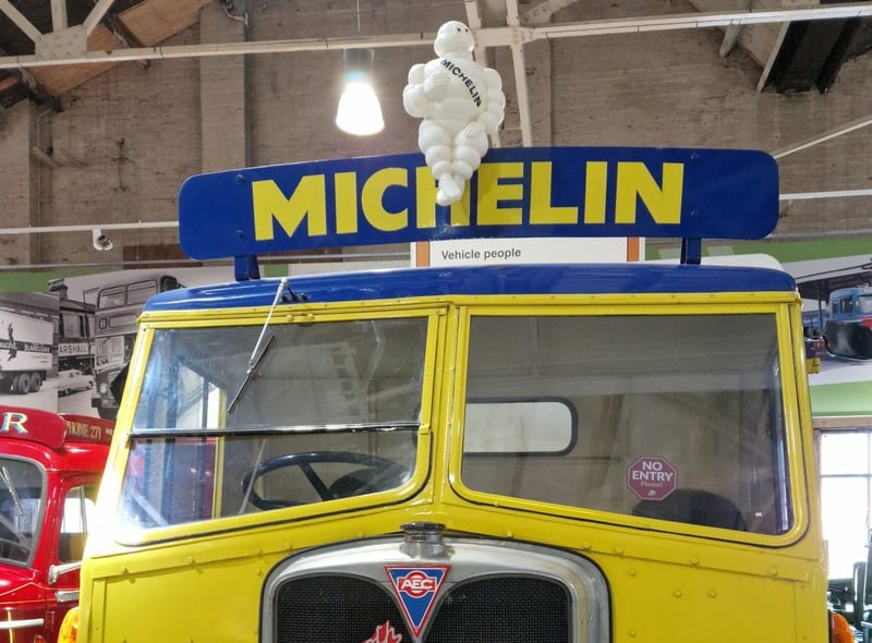 The Michelin Man sits proudly on top of an old truck