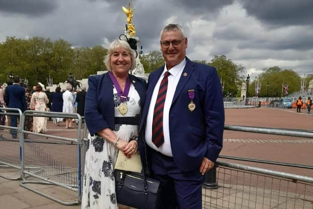 Coun Morgan and her husband Clive at Buckingham Palace