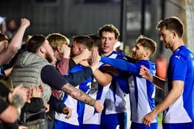 The Latics players celebrate Dale Taylor's penalty at Exeter with the away end