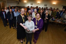 Maureen Holcroft, front left, and Karen Strong, right, from Daffodils Dreams, are presented with a £1,000 cheque by Pauline Clemson, centre, and members of Wigan and Leigh NHS Friendship Club