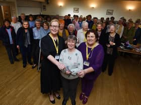 Maureen Holcroft, front left, and Karen Strong, right, from Daffodils Dreams, are presented with a £1,000 cheque by Pauline Clemson, centre, and members of Wigan and Leigh NHS Friendship Club