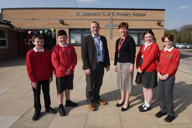 Deputy Director of Education Diocese of Manchester Liam Eaglestone with headteacher Jill Southern and pupils at St Stephen's C E Primary School, Astley, are delighted with the good Ofsted report.