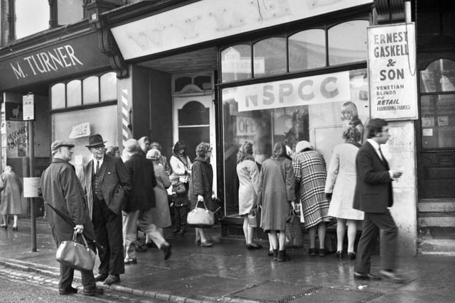 Plenty of interest at the opening of an NSPCC charity shop in Woodcock Street, Wigan, in 1971.