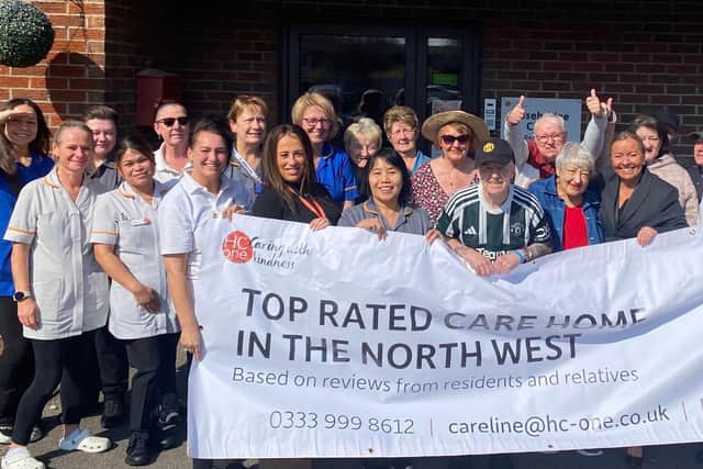 Rosebridge Court colleagues and residents holding up their Top 20 Carehome.co.uk awards banner